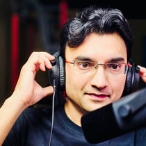 Mac Goswami at the microphone recording Inside AsembleAI